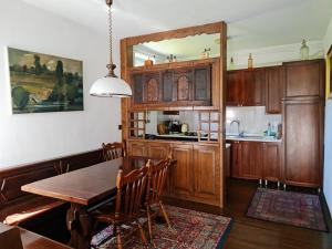 a kitchen with a wooden table and a dining room at Holiday House Jasna in Kranjska Gora