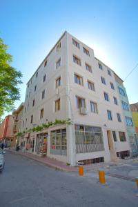 a large white building on the corner of a street at Birlik Apart Hotel in Istanbul