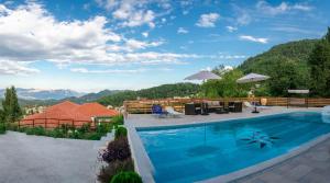 a swimming pool with a view of mountains at Petronas Villa in Kariá