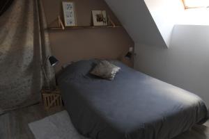 a small bedroom with a bed in a attic at Duplex charmant idéalement situé in Dole