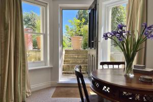 a dining room with a table and a window at Lavender Apartment - Spacious apartment close to the beach in Deal