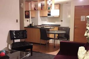 a kitchen and living room with a table and chairs at Lomas de San Andrés in Concepción