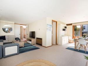 a living room with a couch and a table at Beach Street Residence Huskisson in Huskisson