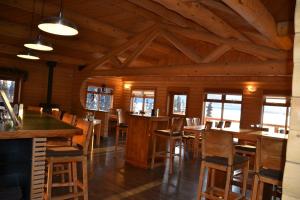 a dining room with wooden tables and chairs at Southern Lakes Resort in Tagish