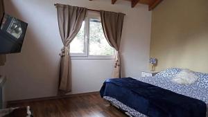 Un pat sau paturi într-o cameră la Rincón del Llao