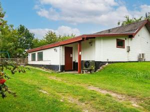 a white house with a red roof at 8 person holiday home in Ebeltoft-By Traum in Ebeltoft