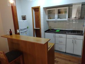 uma cozinha com armários brancos e uma bancada em Casa Laura Dto 1 em San Carlos de Bariloche