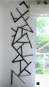 a wall art with black arrows hanging on a wall at Book House Marina Diamante in Acapulco