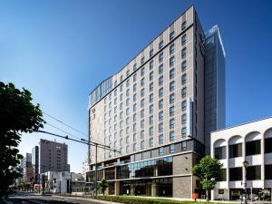 a tall building on a city street at Daiwa Roynet Hotel Yamagata Ekimae in Yamagata