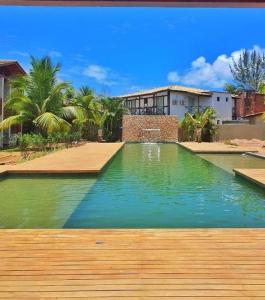 a large swimming pool in front of a house at Apartamento luxo Barra Grande Península de Maraú in Marau