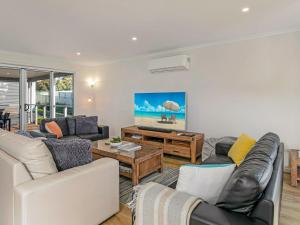 a living room with a couch and a table at A Perfect Ten in Cowes