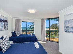 a bedroom with two beds and a view of the ocean at Calypso Plaza Resort Unit 462 in Gold Coast +18 photos