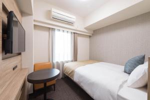 Ένα ή περισσότερα κρεβάτια σε δωμάτιο στο Flexstay Inn Sakuragicho