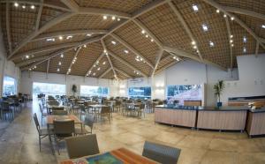 a restaurant with tables and chairs in a large room at Apartamento Resort do Lago in Caldas Novas