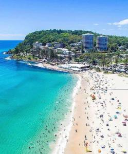 an aerial view of a beach with people in the water at Oceania on Burleigh Beach in Gold Coast