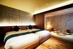 a bedroom with a large white bed in a room at Kikokutei Bekkan in Kyoto