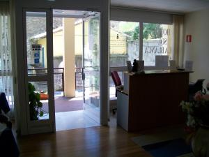 an office with a desk and a door leading to a patio at Hotel Sol de la Blanca in Cudillero