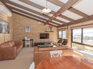 a living room with a couch and a table at Clearview 2 8 Bogong Street in Jindabyne