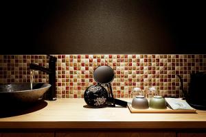 a counter with a sink and a mirror on a table at Kikokutei Bekkan in Kyoto