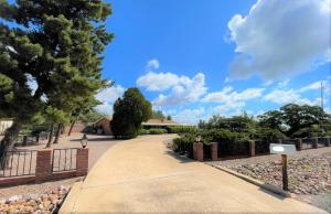 a driveway leading to a house with a fence at Luxe 4BR 2BTH l Pool & Grill l Central Location l Mountain View l Family Vacation l RV Site in Sierra Vista