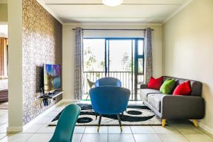 a living room with a couch and a chair at Green Park Haven 1 in Pretoria