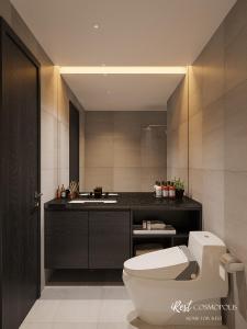 a bathroom with a toilet and a sink at iRest COSMOPOLIS Vinh Yen in Yen