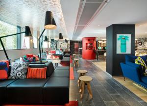 a living room filled with furniture and a fire place at citizenM Paris Champs-Élysées in Paris
