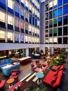 a hotel lobby with tables and chairs and a building at citizenM Paris Champs-Élysées in Paris