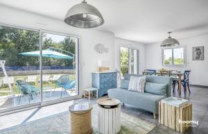 a living room with a couch and a table at Maison vue mer dans le Golfe du Morbihan in Baden