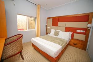 Postel nebo postele na pokoji v ubytování Fini Hotel Bobende