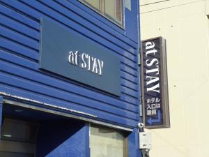 a sign that says at stay on the side of a building at At Stay in Okayama