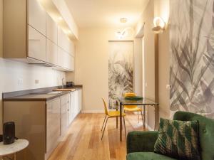 a kitchen and living room with a table and chairs at easyhomes - Vincenzo Monti in Milan