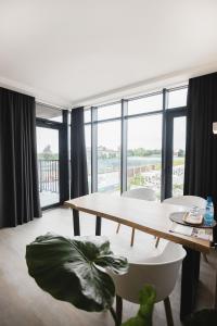 a living room with a table and a large window at Sofia Hotel in Velyka Omelyana