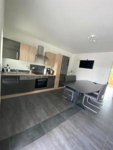 a kitchen with a sink and a table in it at 3 Mehrbettzimmer, Küche, Bad für Arbeiter und Monteure in Gau-Weinheim in Gau-Weinheim