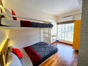 a room with two bunk beds and a desk at Stayinn Nest in Bhopal