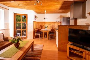 a living room with a couch and a table at Ferienwohnung Hötzelsperger in Prien am Chiemsee