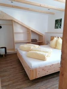 2 Betten in einem Zimmer mit weißen Wänden und Holzböden in der Unterkunft Appartements Wolfgang Auderer in Jerzens