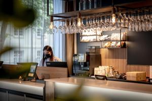 a woman wearing a gas mask in a restaurant at Comfort Hotel Børsparken in Oslo