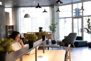 a woman sitting at a table in an office at Comfort Hotel Børsparken in Oslo