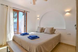 a bedroom with a bed with blue pillows on it at Puerto Chico 2 in Playa Blanca +19 photos