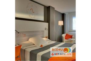 
a hotel room with two beds and two lamps at Hotel Bed4U Pamplona in Cordovilla
