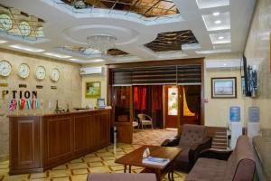 a lobby with a waiting room with a couch and a table at Euro Asia Hotel in Samarkand