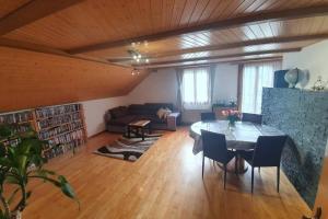 a living room with a table and a couch at Schöne 3 1/2 Zimmer Wohnung in der Zentralschweiz in Menznau