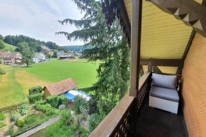 a balcony of a house with a view of a yard at Schöne 3 1/2 Zimmer Wohnung in der Zentralschweiz in Menznau