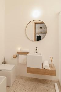 a bathroom with a white sink and a mirror at La Dimora Di Metello in Matera
