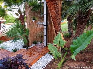 un giardino con ingresso a una recinzione di legno con piante di Il Casale Del Sogno ad Ardea