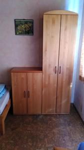 a large wooden cabinet in a room with a bed at Fewo Frank in Aspach