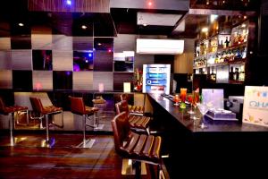 a bar with chairs and a counter in a restaurant at The Theme, Jaipur in Jaipur