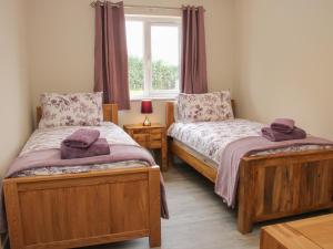 Ένα ή περισσότερα κρεβάτια σε δωμάτιο στο Holly Lodge