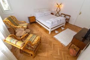 a bedroom with a bed and two chairs and a table at Апартамент BOHO CHIC Free parking in Varna City